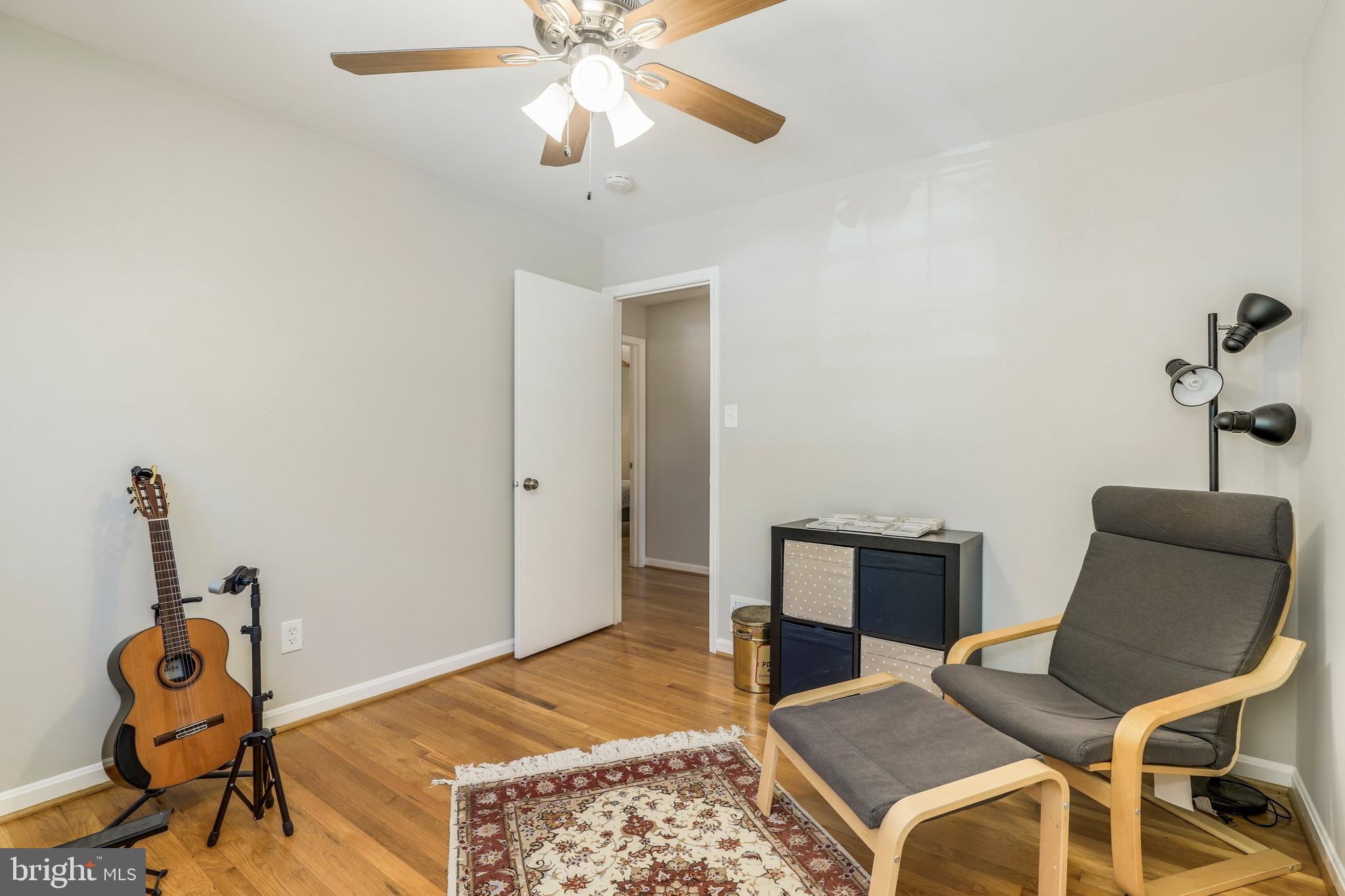 8461 Thames Street Springfield, VA 22151 - Photo 38 of 57 a bedroom with a bed and wooden floor