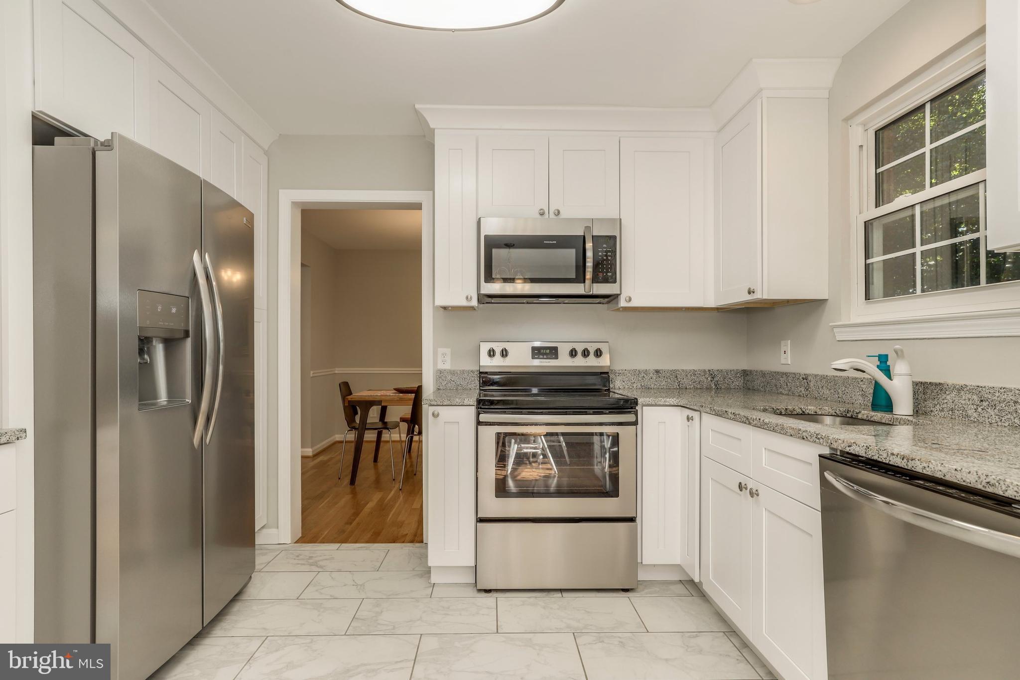 8461 Thames Street Springfield, VA 22151 - Photo 9 of 57 a kitchen with stainless steel appliances granite countertop a refrigerator stove and sink