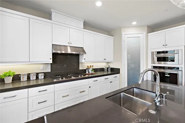 a large kitchen with a table and chairs