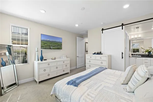 a bedroom with a large bed and a window