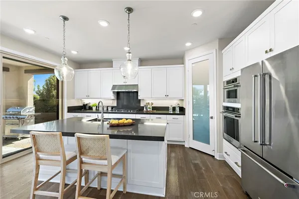 a kitchen with a table chairs stove and kitchen view