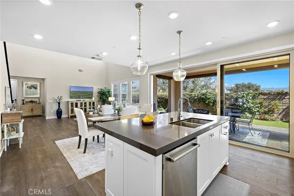 a kitchen with stainless steel appliances granite countertop a stove refrigerator sink and cabinets