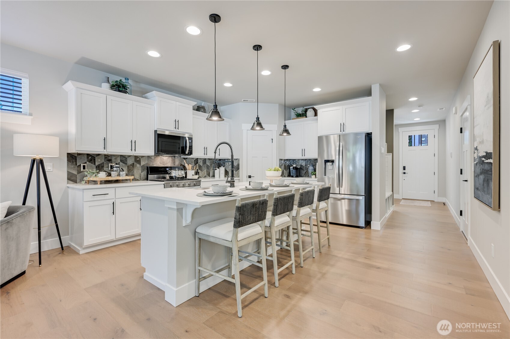 19224 Meridian Drive Southeast, Unit CW 09 Bothell, WA 98012 - Photo 8 of 37 a kitchen with kitchen island white cabinets and stainless steel appliances