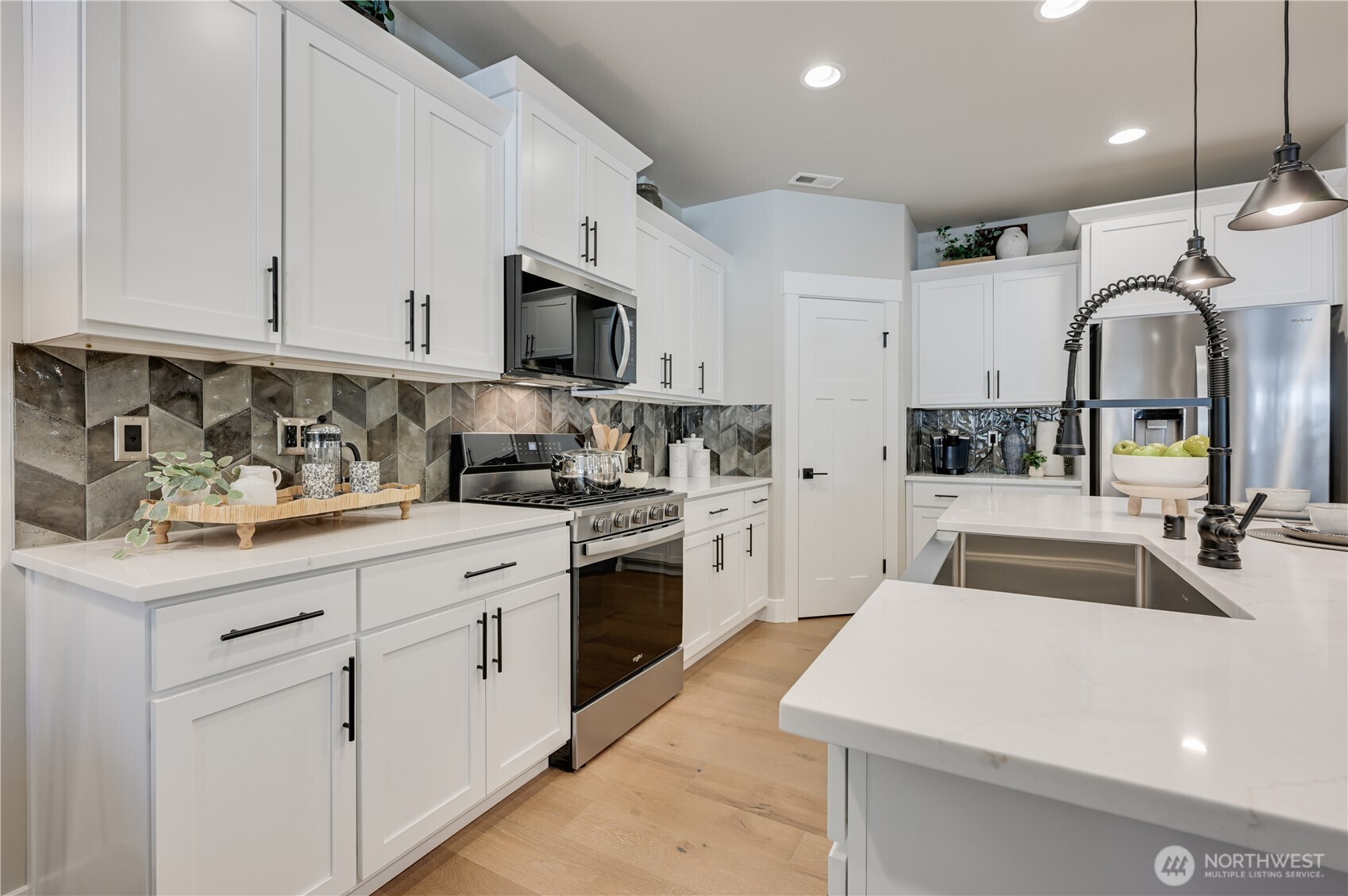 19224 Meridian Drive Southeast, Unit CW 09 Bothell, WA 98012 - Photo 9 of 37 a kitchen with sink a stove and cabinets