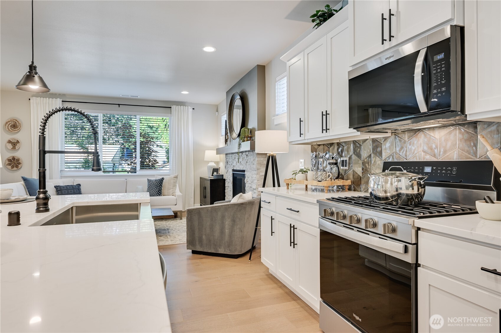 19224 Meridian Drive Southeast, Unit CW 09 Bothell, WA 98012 - Photo 10 of 37 a kitchen with stainless steel appliances granite countertop a stove a sink and a microwave