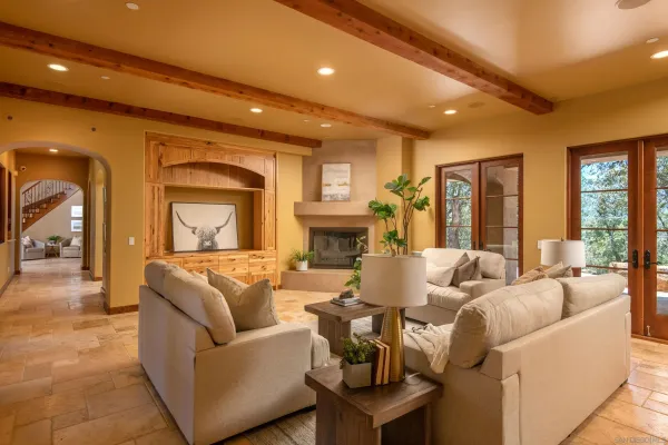 a living room with fireplace furniture and a large window
