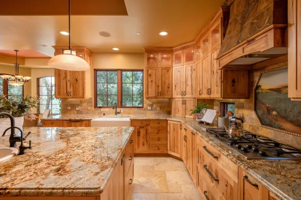 a large kitchen with stainless steel appliances granite countertop a sink and a stove