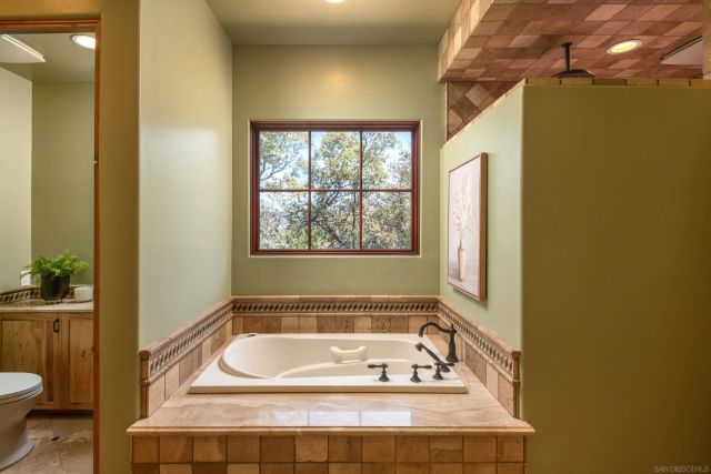 a bathroom with a bathtub and window