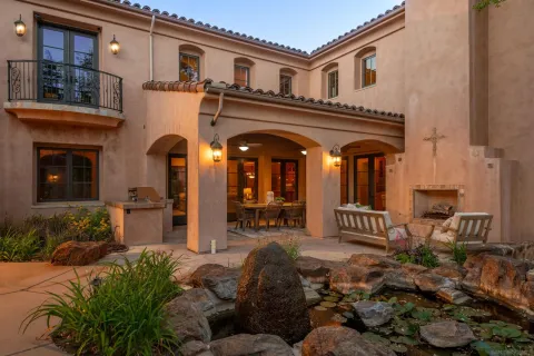 a front view of a house with outdoor seating