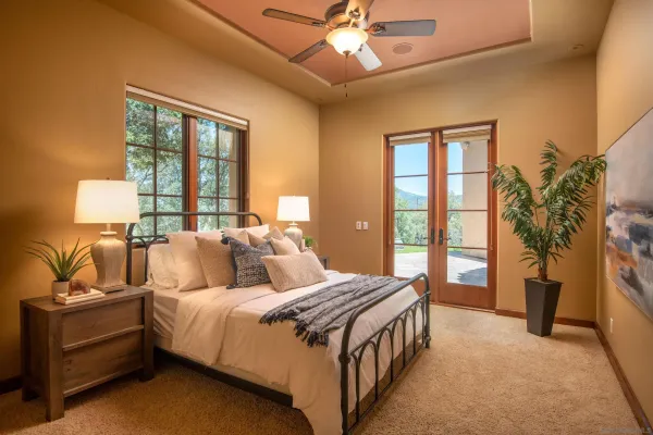 a bedroom with a bed and a chandelier