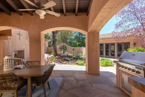 a view of a patio with a table and chairs
