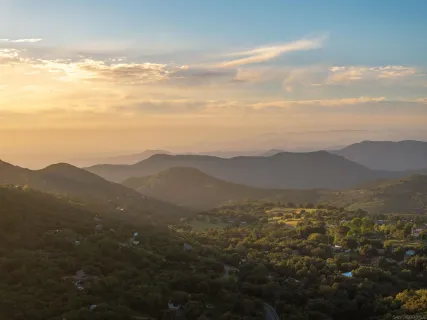 a view of an mountain range with lush green forest