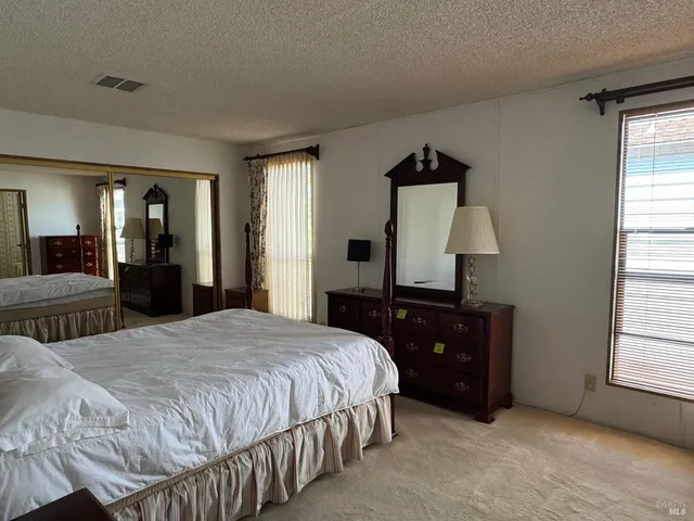 a bedroom with a bed and a dresser