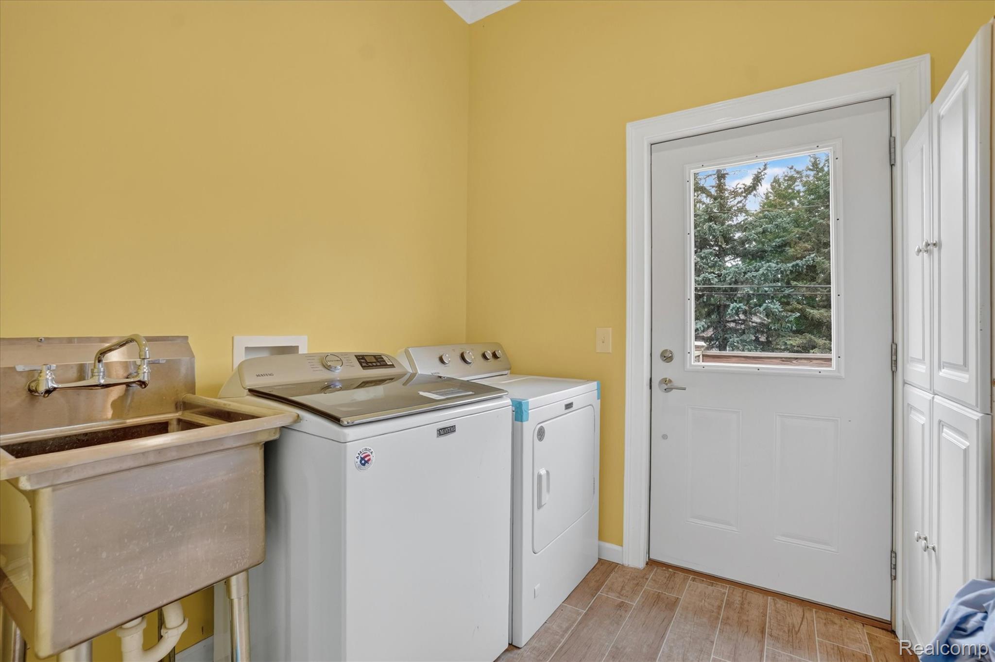 6524 Kelly Road Flushing, MI 48433 - Photo 28 of 47 Utility room with a built-in wash basin, wood-finish flooring, and white cabinetry
