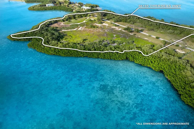 a blue swimming pool is sitting in the grass of a building