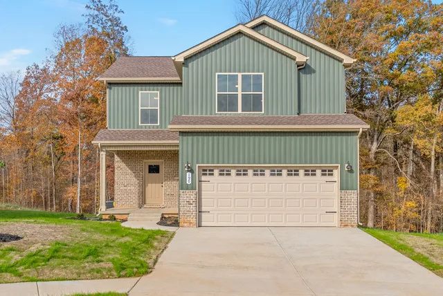 a front view of a house with a yard and garage