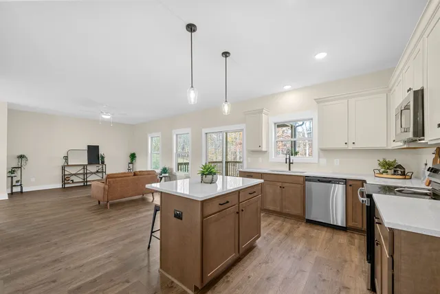 a kitchen with sink cabinets and wooden floor