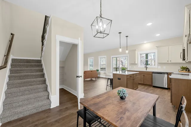 a kitchen with granite countertop white cabinets and stainless steel appliances