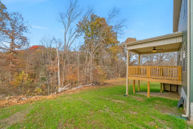 a kitchen with stainless steel appliances kitchen island granite countertop a table chairs sink and cabinets