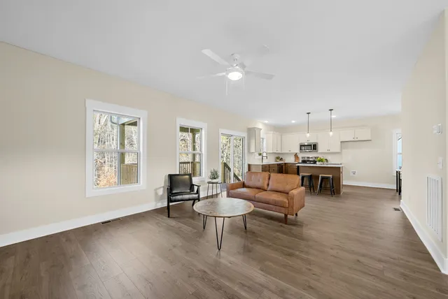 a living room with furniture and a wooden floor