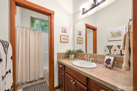 a bathroom with a granite countertop sink and a mirror