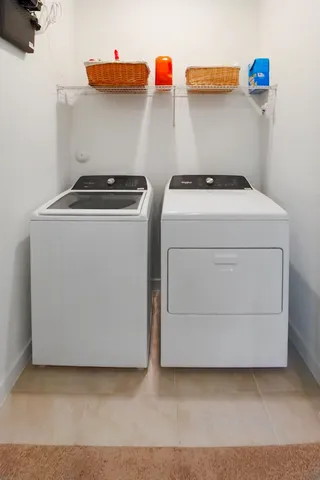 a spacious bedroom with a bed and a chandelier