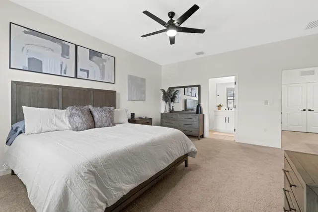 a bedroom with a bed a couch and a window