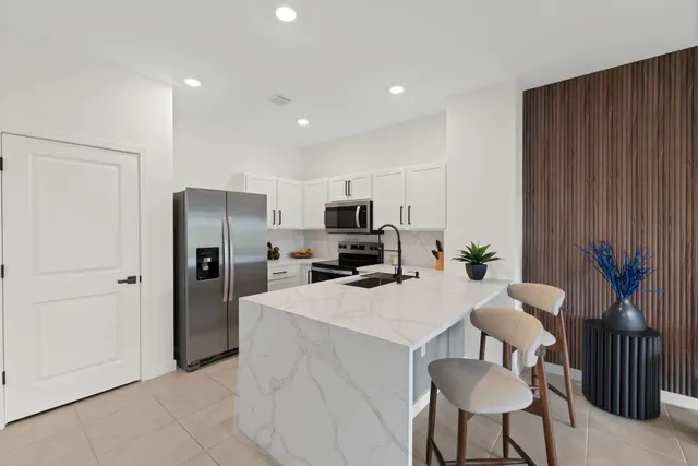 a kitchen with granite countertop a stove and a sink