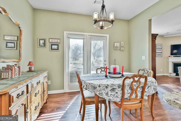 a view of a dining room with furniture window and wooden floor