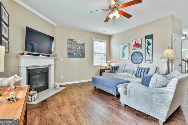 a living room with fireplace furniture and a flat screen tv