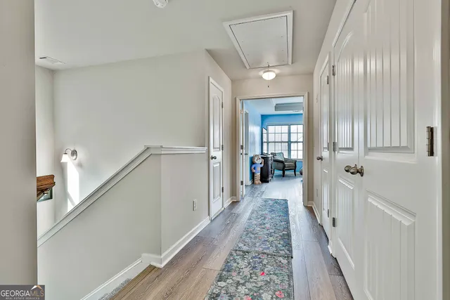 a view of hallway with wooden floor