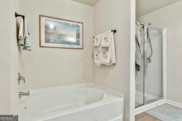 a white bath tub sitting next to a shower
