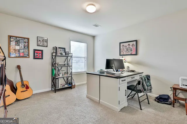 a view of a workspace with furniture and a window