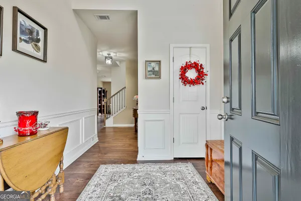a hallway with toys and wooden floor