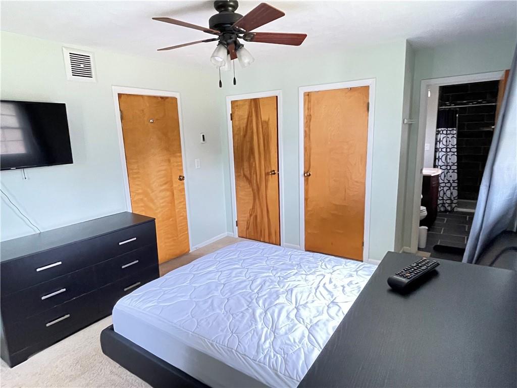 3034 Warren Road Indiana, PA 15701 - Photo 17 of 25 a bedroom with a bed and a flat tv screen on dresser