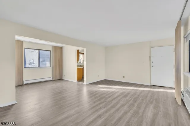 wooden floor in an empty room with a window
