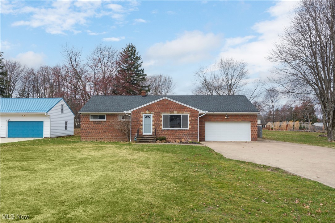 11518 Prospect Road Strongsville, OH 44149 - Photo 1 of 46 Ranch-style house featuring a front lawn, an attached garage, brick siding, and concrete driveway
