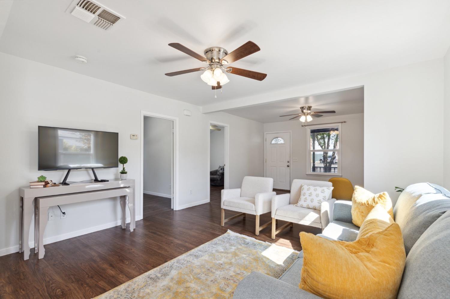 220 Sunnyside Avenue Clovis, CA 93612 - Photo 11 of 38 a living room with furniture and a wooden floor