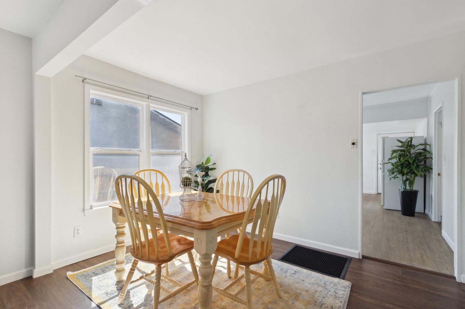 220 Sunnyside Avenue Clovis, CA 93612 - Photo 12 of 38 a view of a dining room with furniture and wooden floor