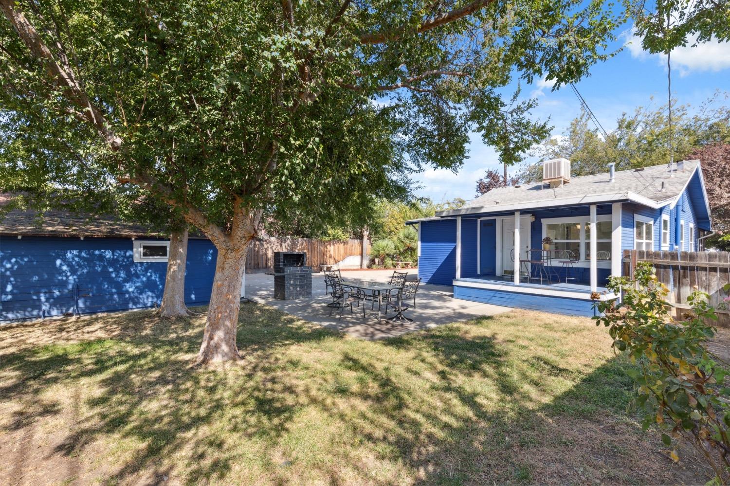220 Sunnyside Avenue Clovis, CA 93612 - Photo 25 of 38 a view of a house with a large tree and a yard