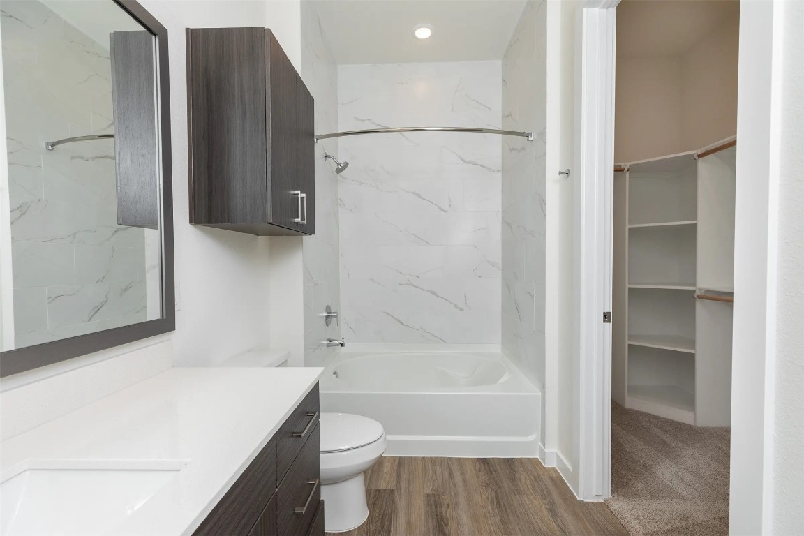 1690 North Loop, Unit 479 Houston, TX 77009 - Photo 13 of 28 a bathroom with a bathtub a toilet and a shower
