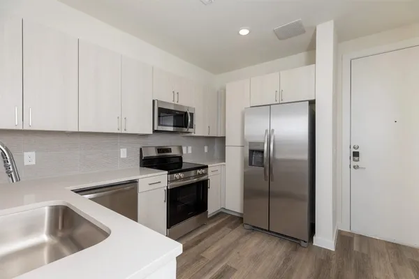 a kitchen with a refrigerator sink and microwave