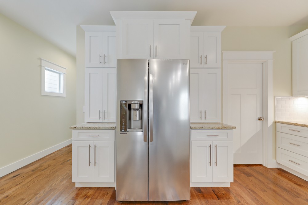 1332 B Lischey Avenue Nashville, TN 37207 - Photo 14 of 40 a kitchen with white cabinets and stainless steel appliances