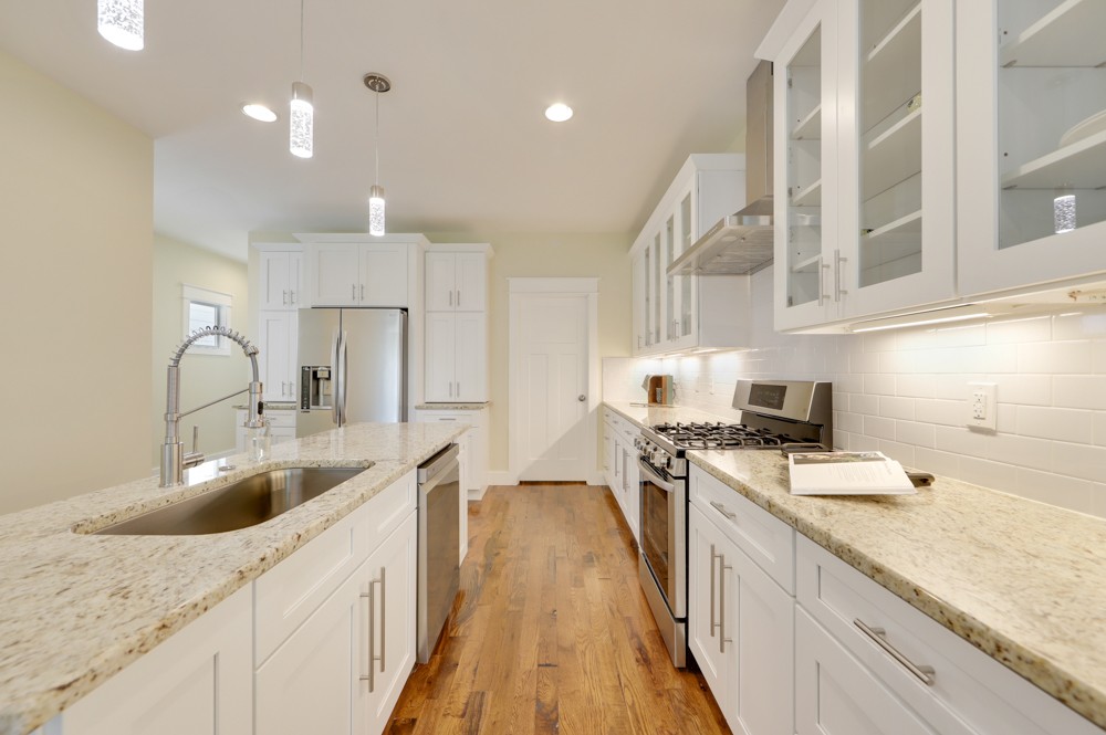 1332 B Lischey Avenue Nashville, TN 37207 - Photo 17 of 40 a kitchen with kitchen island granite countertop a sink a counter space appliances and cabinets