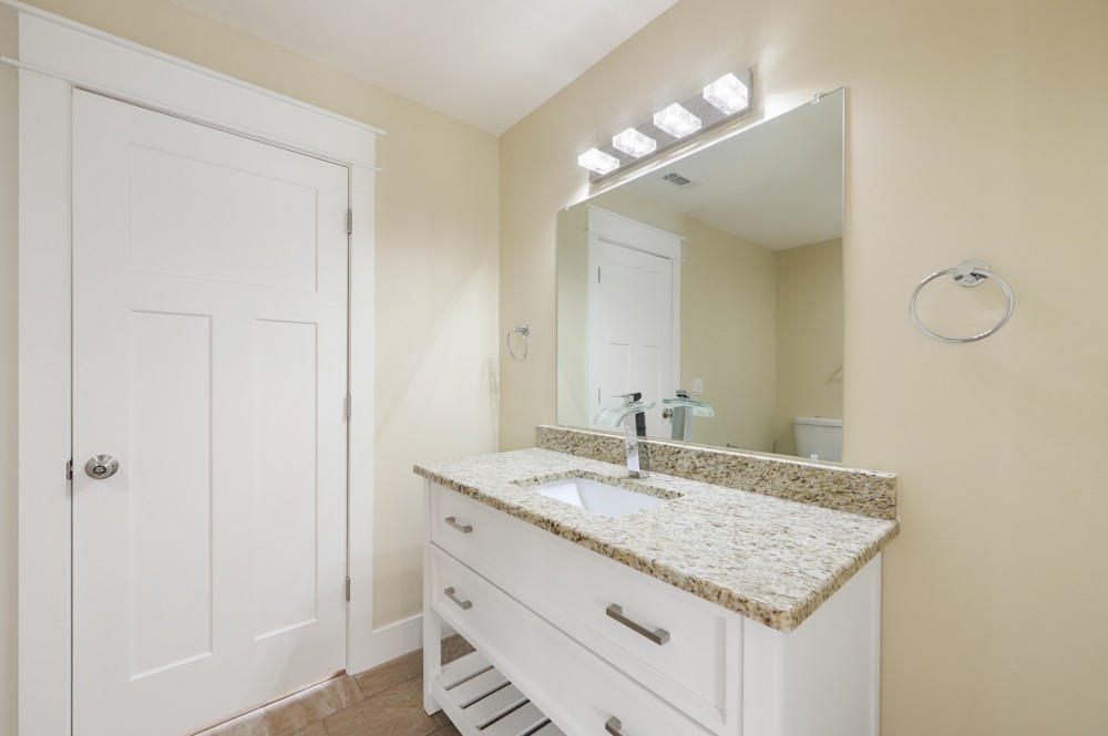 1332 B Lischey Avenue Nashville, TN 37207 - Photo 25 of 40 a bathroom with a granite countertop sink and a mirror