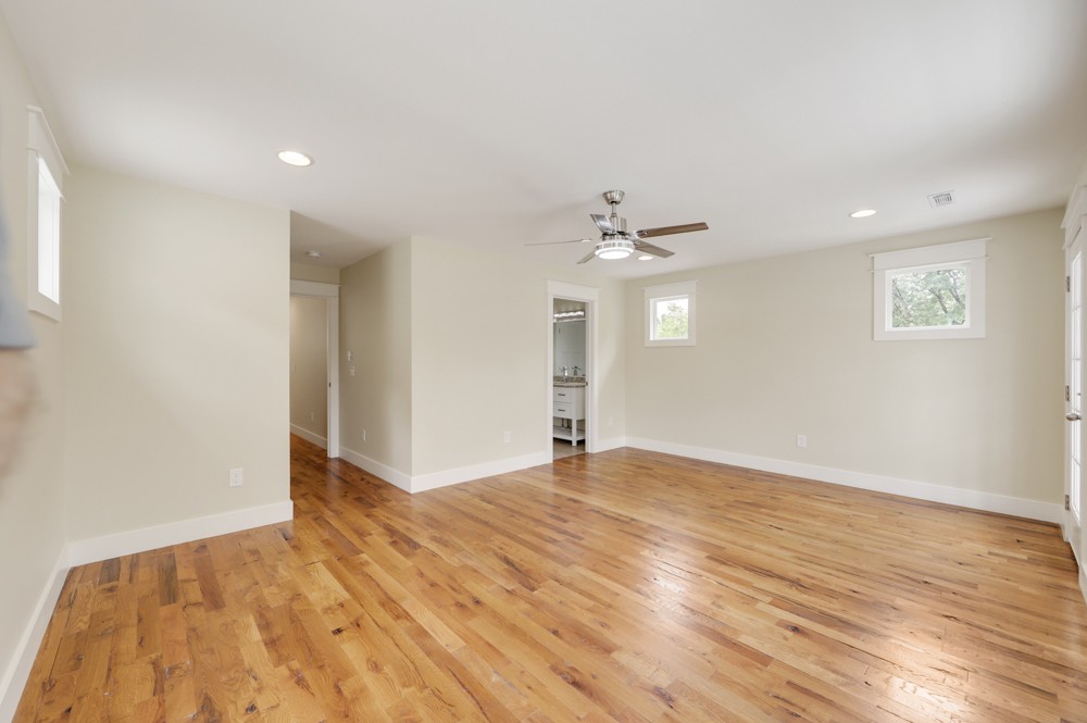 1332 B Lischey Avenue Nashville, TN 37207 - Photo 27 of 40 a view of an empty room with wooden floor and a ceiling fan