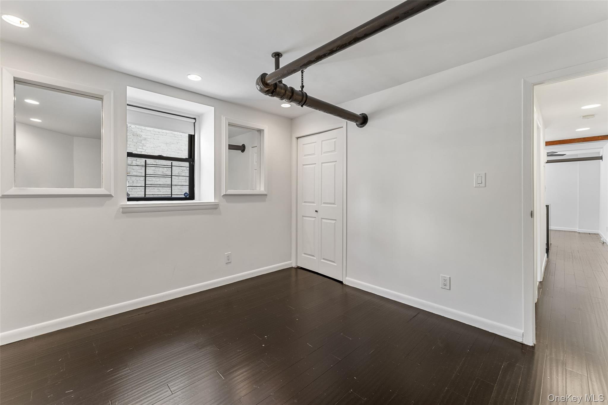 56 Pondfield Road West, Unit A Bronxville, NY 10708 - Photo 14 of 24 a view of empty room with wooden floor and fan
