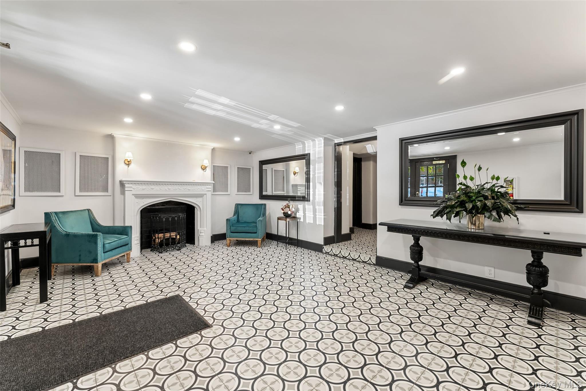56 Pondfield Road West, Unit A Bronxville, NY 10708 - Photo 18 of 24 a living room with furniture a fireplace and a table