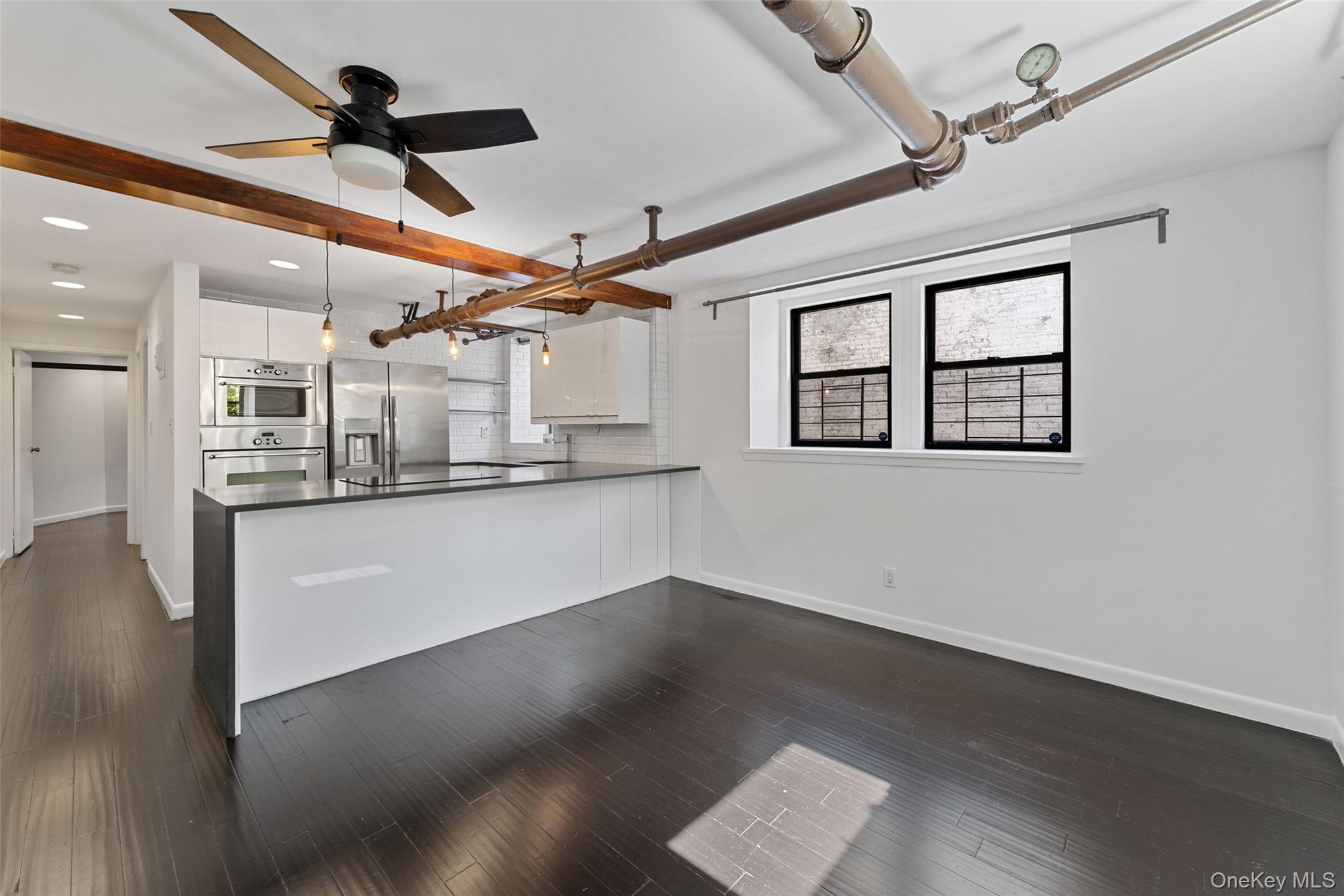 56 Pondfield Road West, Unit A Bronxville, NY 10708 - Photo 10 of 24 a view of a kitchen with wooden floor and a ceiling fan