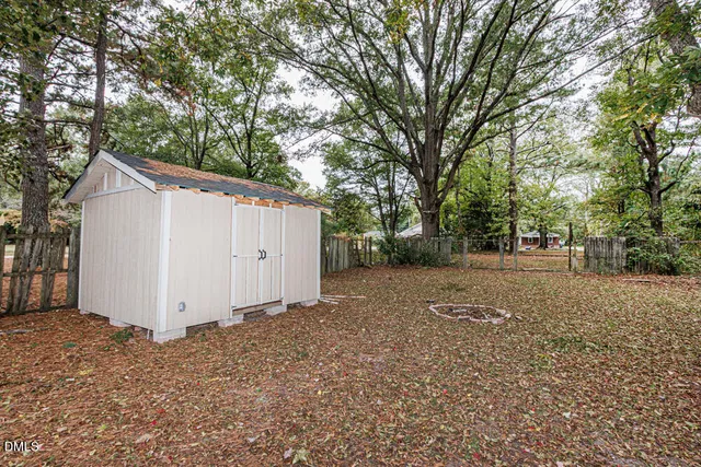 a view of a backyard with large trees